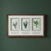 A ceramic wall art piece titled "Native Irish Fern Leaf" features an original design and is displayed with a wooden frame on a dark green wall.