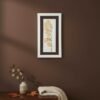 The Large Colourful Meadow Mix – Fine Art Print hangs on a brown wall above a wooden table with a vase of eucalyptus branches, a cream knit blanket, and scattered autumn leaves.