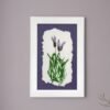 Wild Meadow Mix (Medium): A framed botanical artwork by an Irish artist, showcasing two purple flowers with green stems and leaves on torn-edged white paper, set on a dark purple background and displayed on a light gray wall.