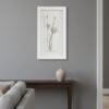 A minimalist living room with a gray wall features "Dill – Original Ceramic Wall Art," a dark wood console table, a light ceramic vase, and part of a light gray sofa.