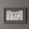 The "Wild Meadow Mix (Medium)" is a framed artwork featuring delicate black line drawings of wildflowers and plants on a white background, created by an Irish artist and displayed against a gray wall.