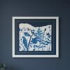 The Rosemary – Original Ceramic Wall Art showcases blue botanical silhouettes inspired by Irish art, framed and displayed on a dark blue wall with green plant leaves visible in the lower left corner.