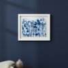 The Rosemary – Original Ceramic Wall Art, inspired by Irish design in blue and white, hangs on a dark blue wall above a wooden table with a small ceramic vase and a cream knitted blanket draped over the edge.