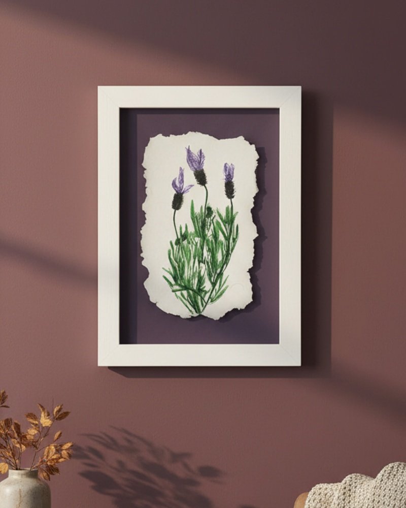 Dill – Original Ceramic Wall Art shows three purple lavender flowers on torn white paper in a frame, hanging on a mauve wall with sunlight casting soft shadows and dried plants in the foreground.
