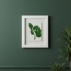 The Dill – Original Ceramic Wall Art, featuring green botanical designs inspired by Irish art, is displayed on a dark green wall. Potted plants in the lower right corner complement both the artwork and the wall color.